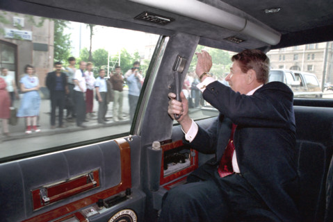 U.S. President Ronald Reagan waving to citizens while Driving in his limousine from Moscow State