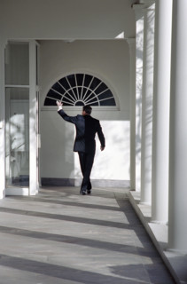 U.S. President Ronald Reagan waving goodbye as he walks along White House Colonnade for the last