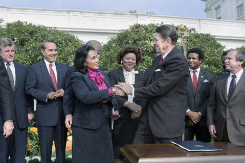 U.S. President Ronald Reagan shaking hands with Coretta Scott King at signing ceremony for HR 3706