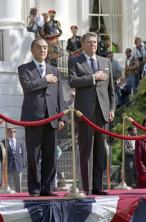 U.S. President Ronald Reagan and Prime Minister Yasuhiro Nakasone  of Japan listening to national