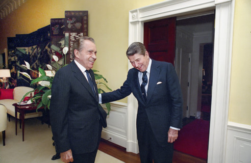 U.S. President Ronald Reagan laughing with former U.S. President Richard Nixon in White House