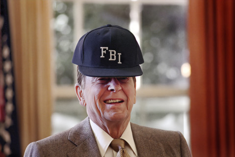 U.S. President Ronald Reagan wearing FBI baseball cap in White house Oval Office, Washington, D.C.,