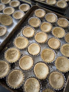 Pre-baked mini tart crusts in baking tin
