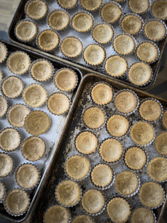 Pre-baked mini tart crusts in baking tin