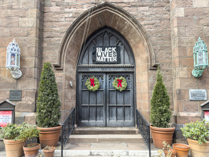 Black Lives Matter sign hanging above entrance to Church of the Ascension, Episcopal church,