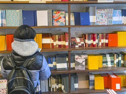 Person shopping for notebooks, Goods For The Study retail store, West Village, Manhattan, New York