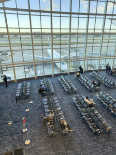 High angle view of travelers relaxing in departure lounge, Delta Airlines, Fort