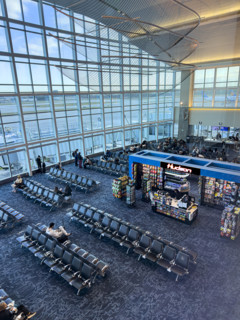 High angle view of travelers relaxing in departure lounge, Delta Airlines, Fort