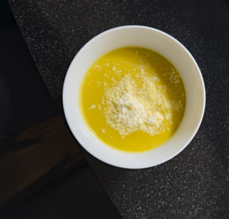 High angle view of a bowl of butternut squash soup sprinkled with parmesan cheese