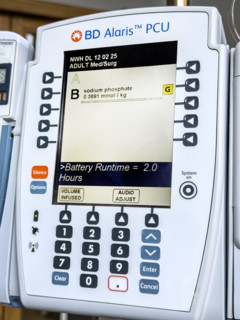 Close-up detail of BD Alaris PCU IV pump machine in hospital room