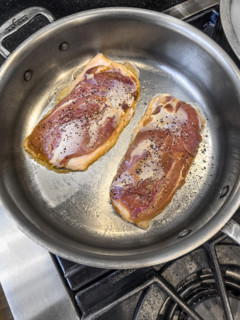 High angle view of sauteed duck breast in pan