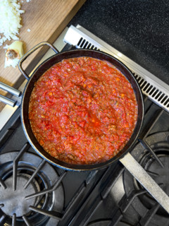 High angle view of bolognese sauce simmering in pot on stove