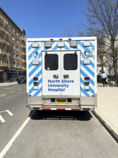 Rear view of North Shore University Hospital Northwell Health EMS ambulance parked on urban street,