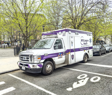 NYU Langone Health EMS ambulance parked on urban street, Chelsea, Manhattan, New York City, New