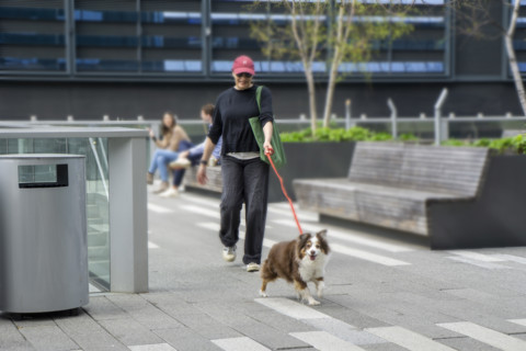 Woman walking her dog in urban park