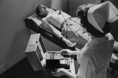 Nurse taking electrocardiogram of male patient, Warren K. Leffler, U.S. News & World Report