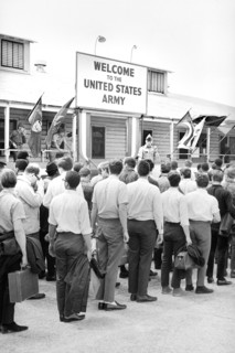 Draftees lined outside a building with a sign "Welcome to the U.S. Army", Fort Jackson, South