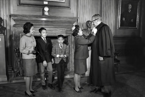Thurgood Marshall, Associate Justice of the U.S. Supreme Court, assisted with his robes by his wife