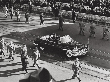 U.S. President Harry S. Truman and U.S. Vice President Alben Barkley wave to crowds their car
