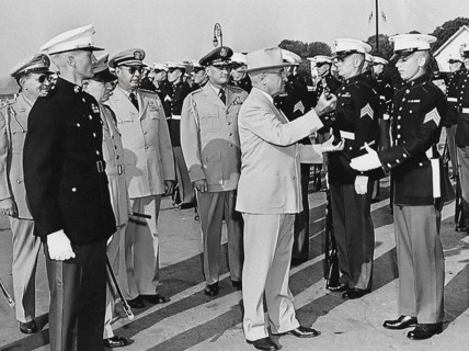 U.S. President Harry S. Truman inspecting rifle of unidentified Marine during visit to U. S. Marine