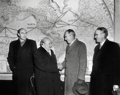 British Prime Minister Winston Churchill (left center) shaking hands with U.S. Secretary of State