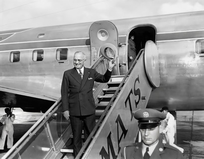 U.S. President Harry S. Truman waving from airplane steps at Washington National Airport prior to