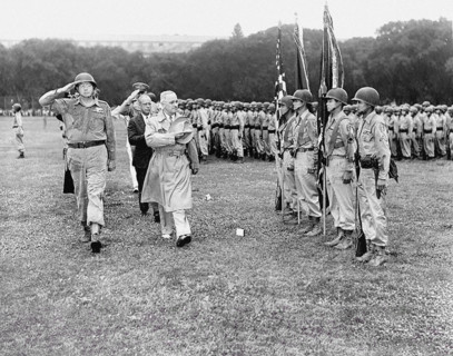 Four Nisei soldiers present the colors as U.S. President Harry S. Truman reviews 442nd Regimental