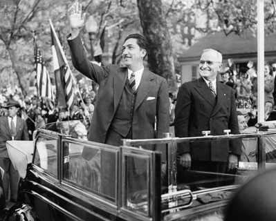 Mexican President Miguel Aleman (left) waving to crowd as U.S. President Harry S. Truman (right)