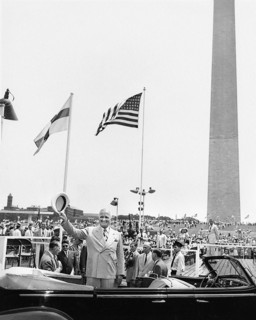 U.S. President Harry S. Truman standing in his limousine convertible as he arrived for ceremony
