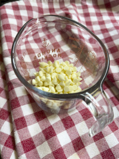 White chocolate chips in glass measuring cup