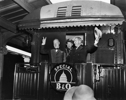 U.S. President Harry S. Truman (right) waving his hat standing to right of former British Prime