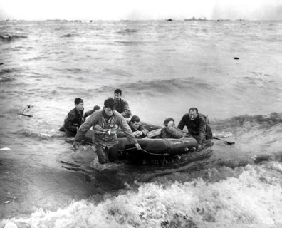 Survivors of sunken LCVP off coast come safely ashore in rubber life raft, Omaha beach, Cherbourg