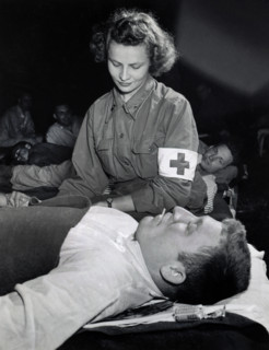 Lt. Elizabeth Babarsik, Canton, Ohio, checking temperature of Private John L. Bennett, Reading,