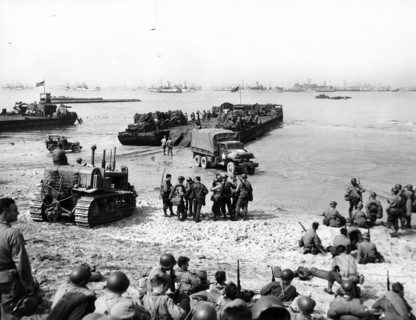 Rhine ferry unloading vehicles and troops on 6th Engineer Special Brigade Beach at Omaha Beach,