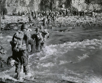 American troops wading through surf before joining additional troops on beachhead, Normandy,
