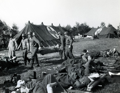 American Medics of 8th Infantry Regiment, 4th Infantry Division, bringing American and British
