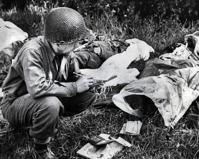 U.S. Sergeant Peter F. Slusarezyk, attached to the Medical Department, tagging a dead American