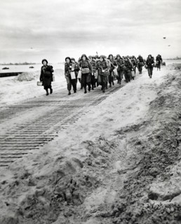 First arrivals of U.S. Women's Army Corps marching from disembarkation pier to transportation and