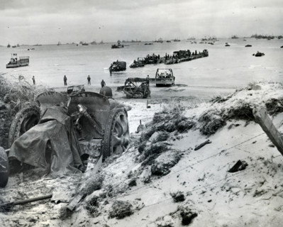 Vehicles of 1st Army Corps being unloaded onto Utah Beach from barge, La Madeleine, Normandy,