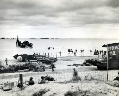 Amphibious trucks bringing in supplies and returning with causalities to the ships for evacuation