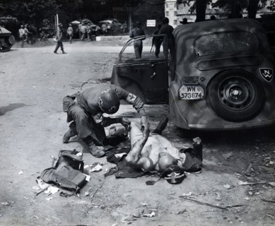 American medic giving first aid to wounded German officer, Chartres, France, U.S. Army Signal