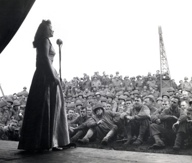 USO singer entertaining American troops of 7th Armored Division, Geldrop, Netherlands, U.S. Army