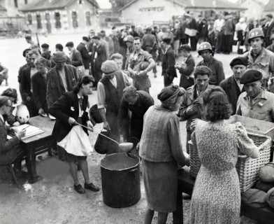 Homeless people who were being cared for by members of civil affairs unit queue up for noonday meal