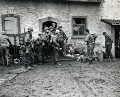 U.S. infantrymen of 16th regiment, 1st Division, U.S. First Army, making final preparations and