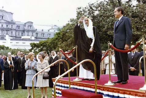 U.S. President Richard Nixon and King Faisal of Saudi Arabia standing on dais with U.S. First Lady