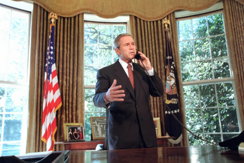 U.S. President George W. Bush talking on telephone with New York Governor George Pataki and New
