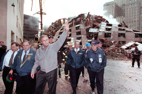 U.S. President George W. Bush waving while touring 7 World Trade Center disaster site with (from