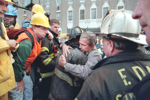 U.S. President George W. Bush embracing firefighter at World Trade Center disaster site, Financial