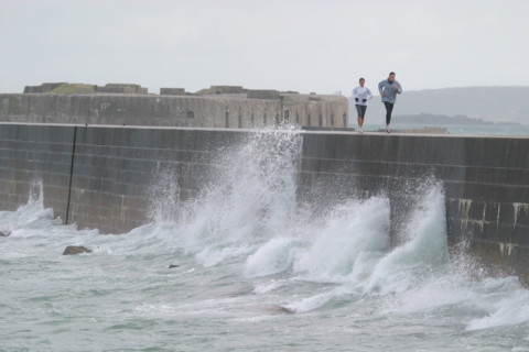 France, Basse Normandie, Manche, Cotentin, Cherbourg, grande rade ouest, querqueville, tempete, gerbes d'eau sur la digue, jogging, personnages qui courent,
