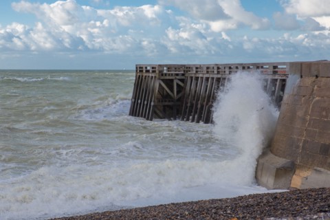 Wave flooding the dyke